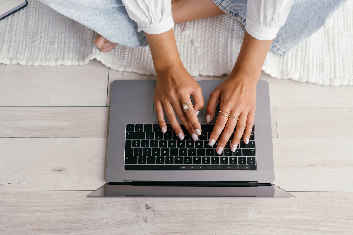 Person in White Shirt Using Macbook Pro